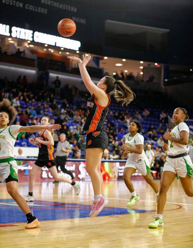 South Hadley’s CC Gurek (11) puts up a shot against Cathedral in the third quarter of the MIAA Div. 4 girls basketball state final Sunday afternoon at the Tsongas Center in Lowell.