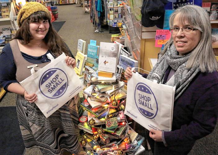 Joan Grenier, right, owner of the Odyssey Bookshop, with Hannah Moushabeck, formerly the director of the store’s Children’s Department, are seen in the store a few years ago. The independent bookshop is 60 years old this month.