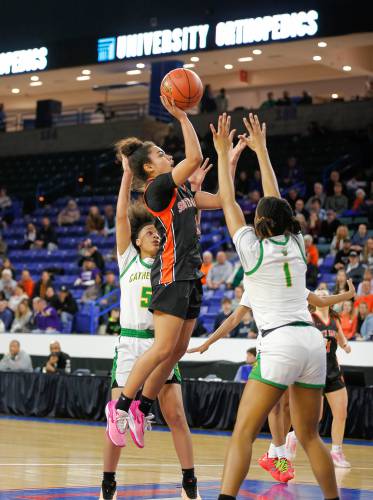 South Hadley’s Drew Alley (1) puts up a shot over Cathedral’s Tamia Darling (1) in the fourth quarter of the MIAA Div. 4 girls basketball state final Sunday afternoon at the Tsongas Center in Lowell.