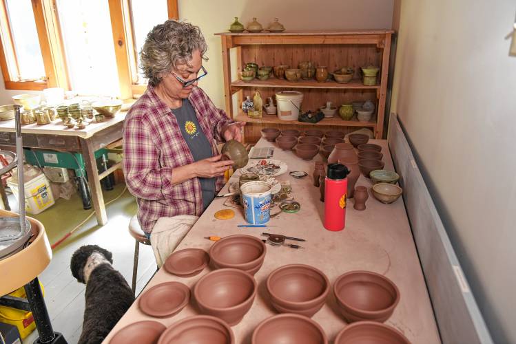 Lucy Fagella, a co-founder of the Pottery Trail, works on her pottery in her Greenfield studio.