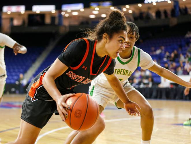 South Hadley’s Drew Alley (1) drives the ball against Cathedral in the fourth quarter of the MIAA Div. 4 girls basketball state final Sunday afternoon at the Tsongas Center in Lowell.