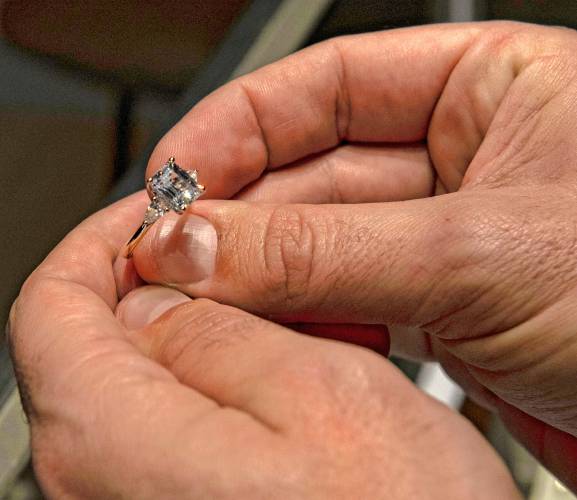 James Murning, owner of Aurora Jewelers, holds one of his rings in his new shop at 106 Union St. in Easthampton. 