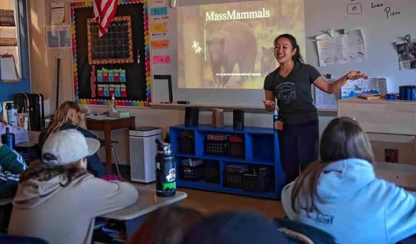 Kaitlyn Huang, a Amherst College student, talks to John Higuera and Ted Prajzner’s fifth grade classes at Hatfield Elementary School about the MassMammals Watch project they are part of. Huang was at the school to help the class install a trail camera.