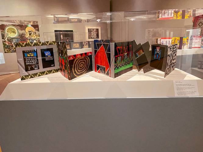 LEFT: “22 Million Beers Powered by the Sun,” accordion book display by Brian D. Tripp. Part of “Boundless” at the Mead Art Museum.RIGHT: “Blueprint,” acrylic on canvas by Amherst College student Maëlle Sannon. Part of “Black Art Matters” at the Mead Art Museum.
