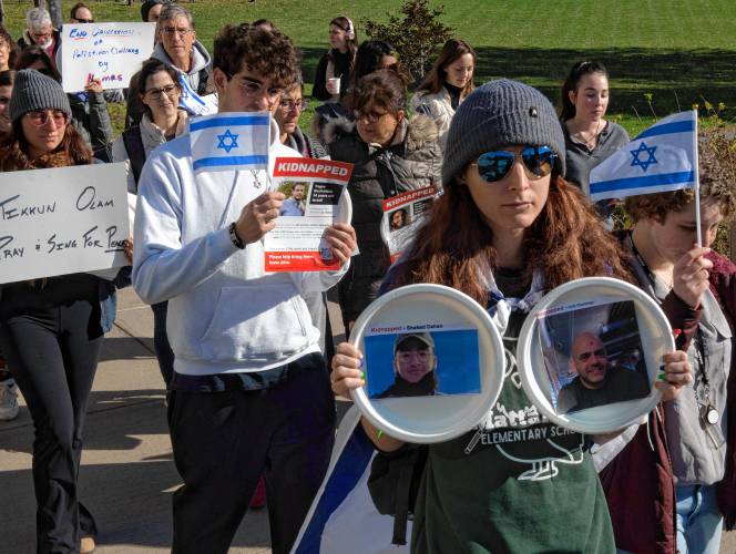 Participants during a UMass event sponsored by UMass Hillel. The participants carried plates with flyers attached during a community event titled Bring Them Home. Each plate was taped to tables in a symbolic ritual of Shabbat honoring the 240 hostages kidnapped from Israel by Hamas.