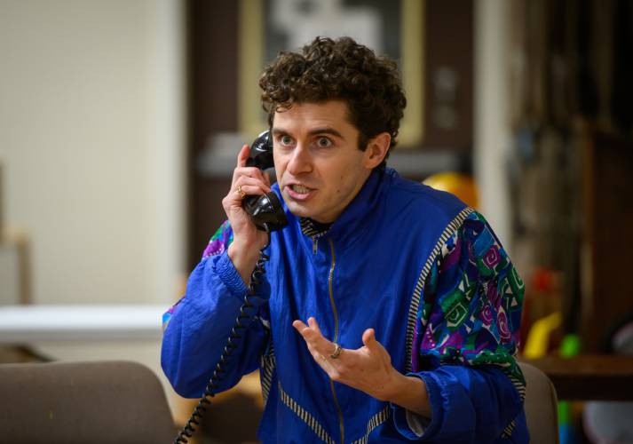Patric Madden grapples with a strange object from the past — a rotary phone — during a rehearsal for “Torch Song” by Easthampton Theater Company.