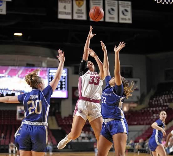 UMass’ Lilly Taulelei (33) pulls up for a shot against Saint Peter’s during the Minutewomen’s season-opening victory on Monday at the Mullins Center in Amherst.