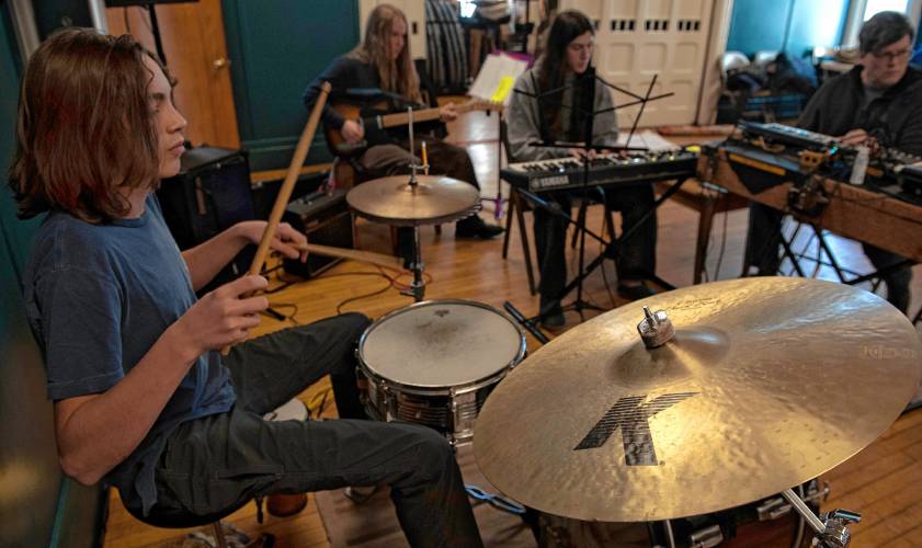 From left, Wiley James, Dylan Kelting-Massaro, and Asher Savage, members of the Hatchery Pit Band, rehearse with keyboardist Mark Gionfriddo, the Young@Heart Chorus music director.