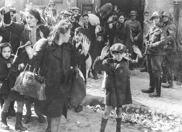 A group of Jews is escorted from the Warsaw Ghetto by German soldiers on April 19, 1943. The picture was used in the war crimes trials in Nuremberg in 1945.