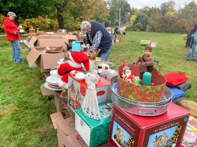 Prospective buyers look over items in a yard sale held to raise money for the Lyndeborough, N.H., Historical Society.