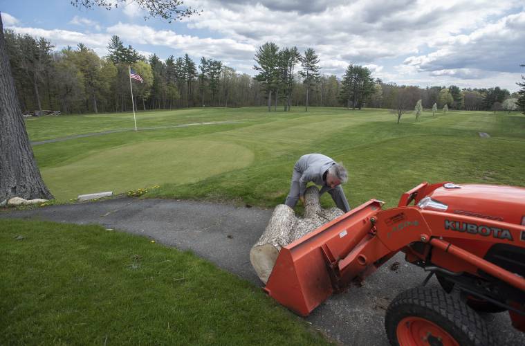 Northampton Country Club pro and owner Jim Casagrande removes a log that had been placed on the first tee to temporarily block access to the 9-hole course in Leeds back in 2020.