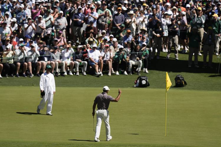 Tiger Woods waves after making a putt on the sixth hole during second round at the Masters golf tournament at Augusta National Golf Club Friday, April 12, 2024, in Augusta, Ga. (AP Photo/Charlie Riedel)