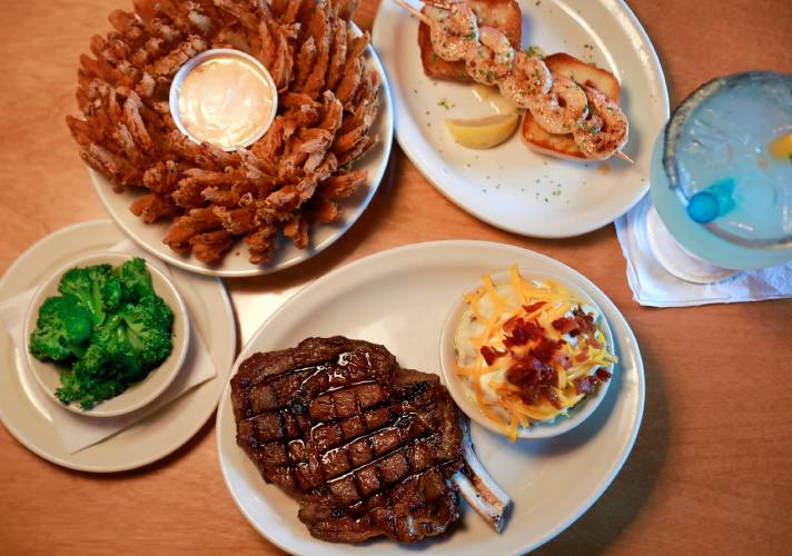 The bone-in ribeye steak with loaded mashed potatoes, broccoli, and the Cactus Blossom and grilled shrimp appetizers along with the Legend Margarita at Texas Roadhouse in Hadley.
