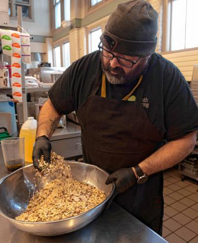 Moises Torres, a chef with residential dining at Smith College, mixes a plant-based recipe for a crunchy cranberry pecan granola bowl during a training with plant-based chefs from the National Humane Society. The recipe called for maple syrup as a sweetener. “Before I would not have thought of it, but honey is a byproduct of an animal and not vegan, which the students very nicely reminded us of,” said Torres.