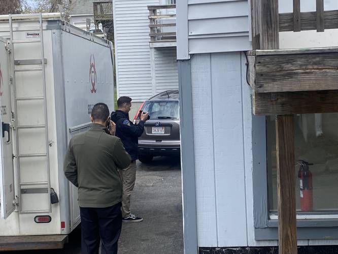 Massachusetts State Police detectives enter an apartment at 92 Chapman St., the former home of murder suspect Taania Herberger-Brown, as a biohazard crew investigates the scene.