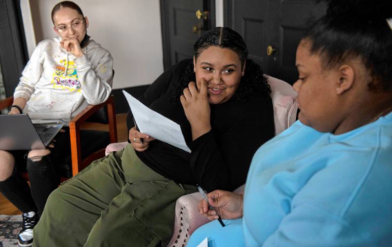 Bella Reeves,left, alumni fellow and leader, listens to Janeyah Madera, a peer leader and youth staff and Nichelle Rivera, a peer leader while leading a group called 