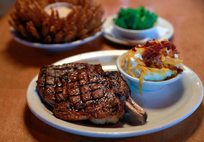 The bone-in ribeye steak with loaded mashed potatoes, broccoli and the Cactus Blossom appetizer on Tuesday afternoon at Texas Roadhouse in Hadley.