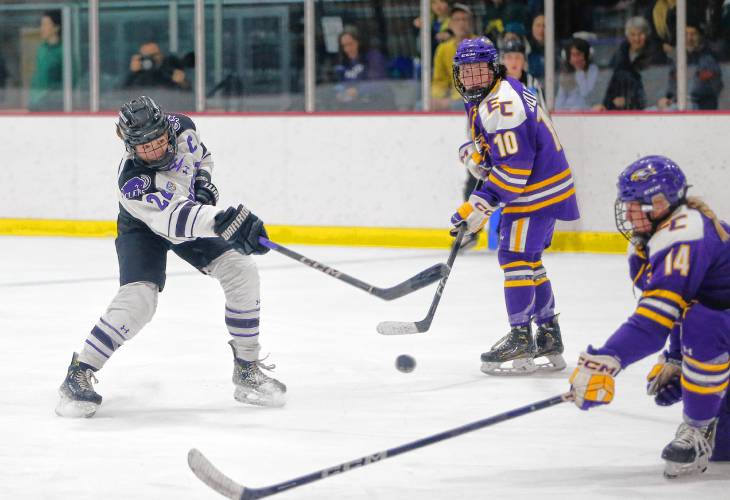 Amherst College’s Rylee Glennon (22) fires a shot against Elmira College in the second period of the NCAA quarterfinals Saturday afternoon at Orr Rink.