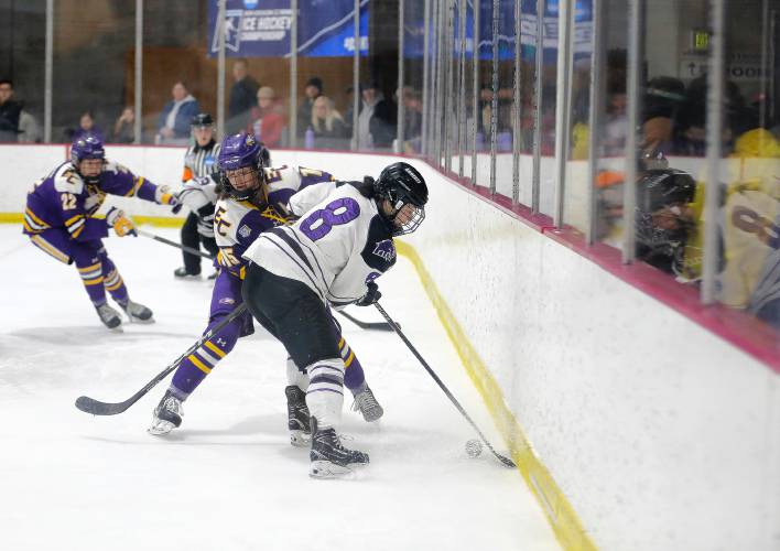 Amherst College’s Ellie DeCarlo (8) battles for the puck against Elmira College’s Lexi Hoffmann (15) in the second period of the NCAA quarterfinals Saturday afternoon at Orr Rink.