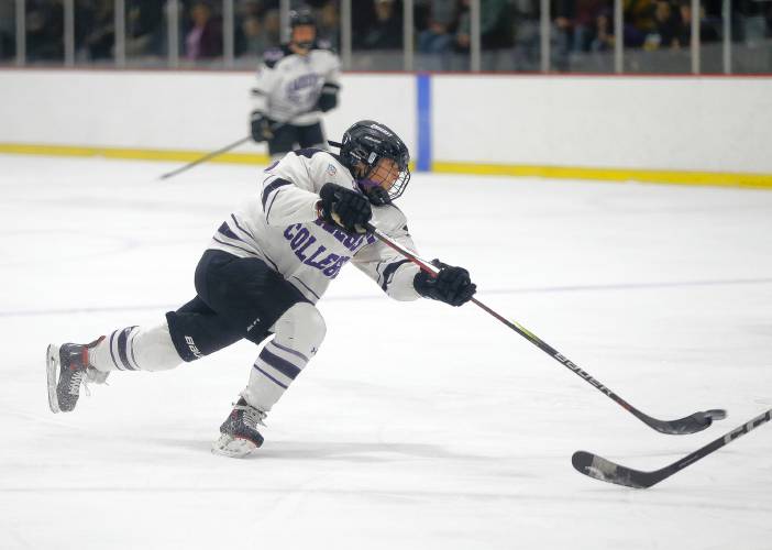 Amherst College’s Anna Baxter (16) fires a shot against Elmira College in the second period of the NCAA quarterfinals Saturday afternoon at Orr Rink.