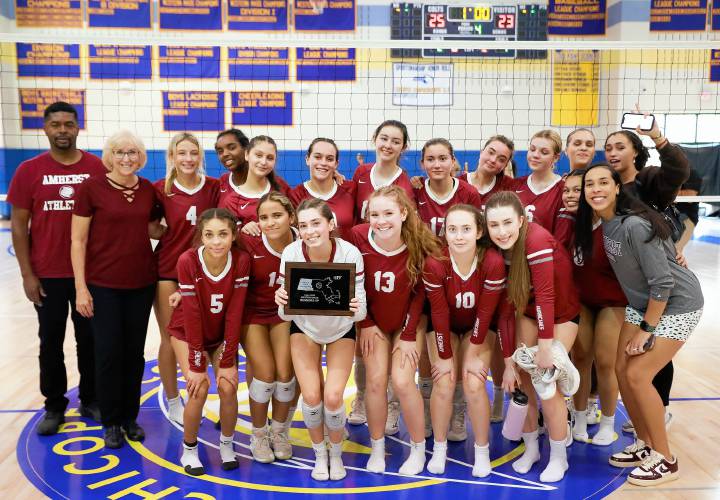Amherst poses for a team photo with the Western Massachusetts Class A girls volleyball runners-up trophy after falling to Longmeadow on Saturday at Chicopee Comp.
