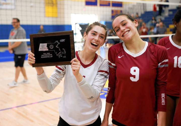 Amherst’s Liza Beigel, left, and Ruby Austin receive the Western Massachusetts Class A girls volleyball runners-up trophy after falling to Longmeadow on Saturday at Chicopee Comp.