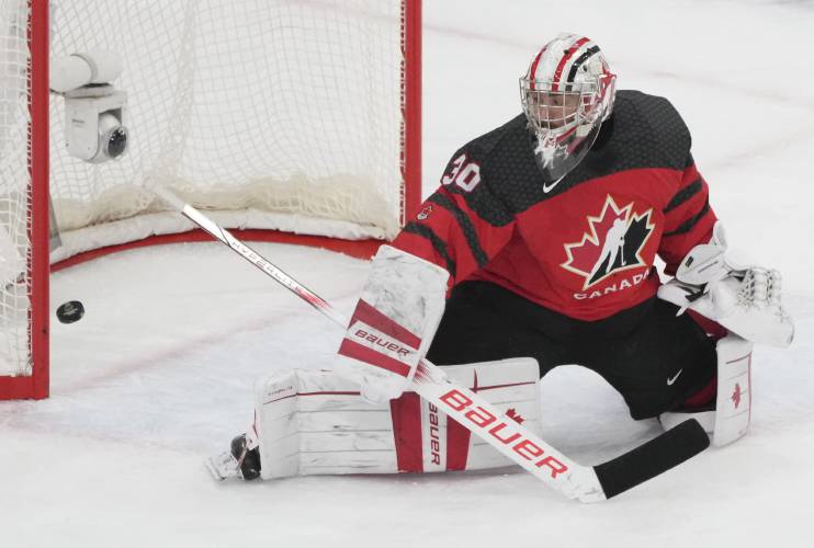 Canada's goaltender Mathis Rousseau (30) looks back as Czechia's Jakub Stancl (not shown) scores in the final seconds of play during the third period in a quarterfinal match at the IIHF World Junior Hockey Championship in Gothenburg, Sweden, Tuesday, Jan. 2, 2024. Christinne Muschi/The Canadian Press via AP)
