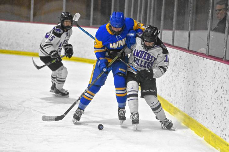 Players from Amherst and Western New England battle for the puck Tuesday at Orr Rink in Amherst.