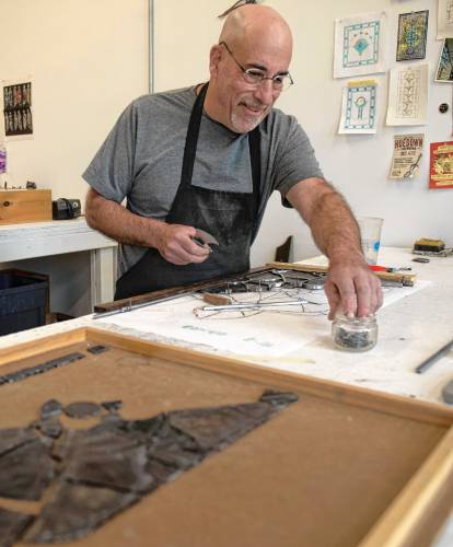 Glenn Shalan, owner of Shalan Stained Glass in Easthampton, works in his studio where he is restoring windows from Riverside Church in New York City.