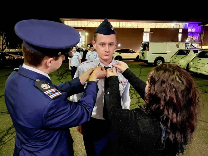 Northampton High School student James Bertone-Johnson, center, a member of the  Brigadier General Arthur J. Pierce Civil Air Patrol Squadron, has been promoted to cadet technical sergeant. At left is  Cadet Capt. Nathaniel Johnston, and at right is 1st Lt. Laurie Stewart, squadron commander.