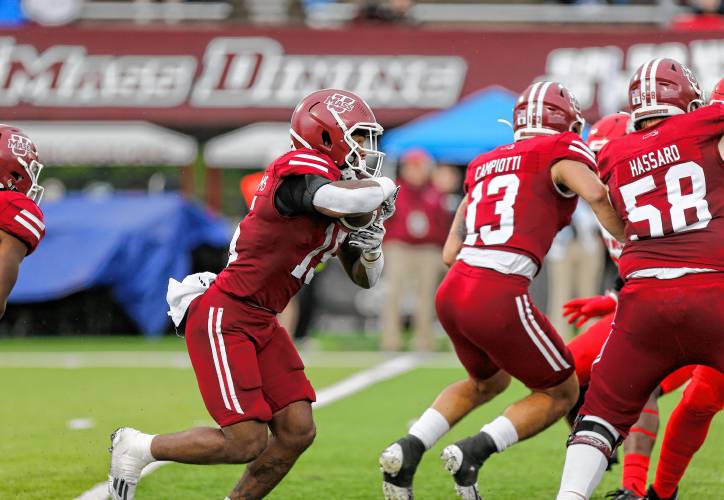 UMass running back Kay'Ron Lynch-Adams (15) rushes against New Mexico earlier this season in Amherst.