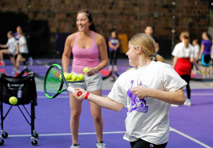 Katie Gromacki, 12, runs through a drill with freshman Lily Dounchis and members of the Amherst College women’s tennis team during National Girls and Women in Sports Day on Saturday at the Alumni Gymnasium and Athletic Complex. 