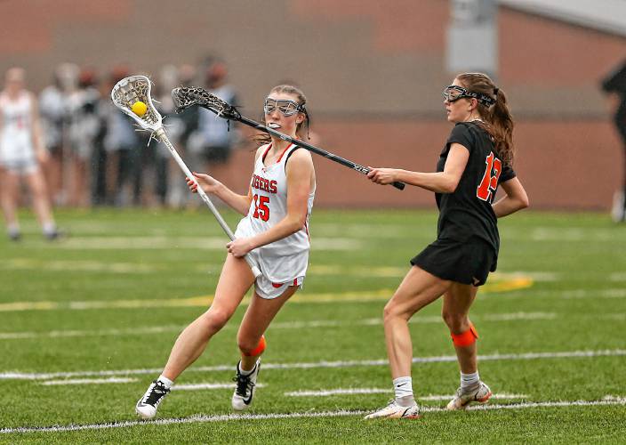 South Hadley’s Maddy McArdle (15) carries the ball upfield defended by Belchertown’s Madysen LePage (12) in the fourth quarter Thursday in South Hadley.