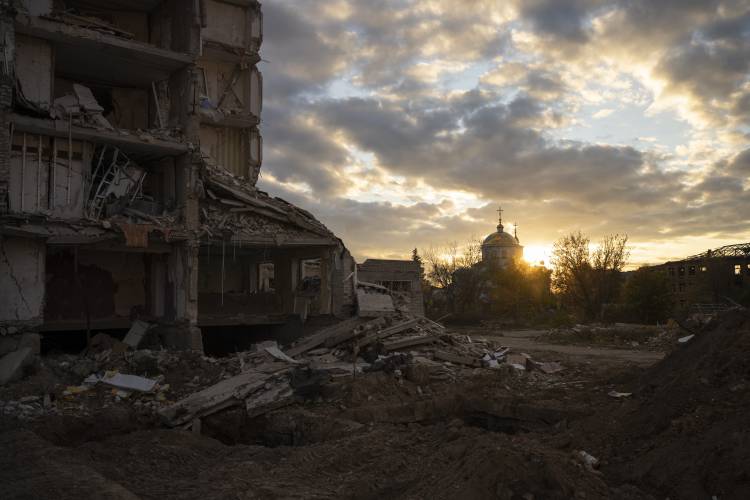 The sun sets over a destroyed building in Izyum, Ukraine, Tuesday, Oct. 24.