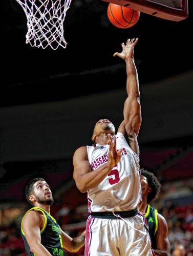 UMass guard Keon Thompson (5) puts in a breakaway layup earlier this season at the Mullins Center in Amherst.