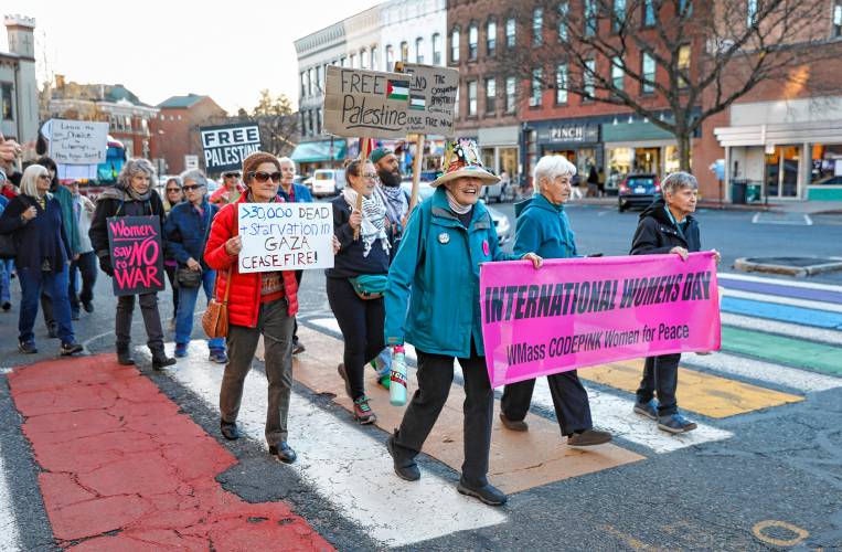 Dozens of community members march down Main Street after rallying at City Hall in Northampton on Friday as part of CODEPINK’s 19th annual celebration of International Women’s Day with the theme, “We mourn, we resist, we organize: Peace & Justice for the Palestinians and all peoples.”