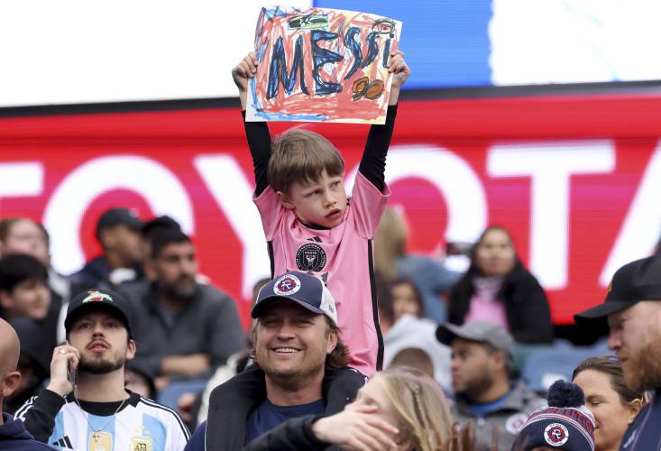 A young fan shows his support for Inter Miami forward Lionel Messi before an MLS  match against the New England Revolution, Saturday in Foxborough.