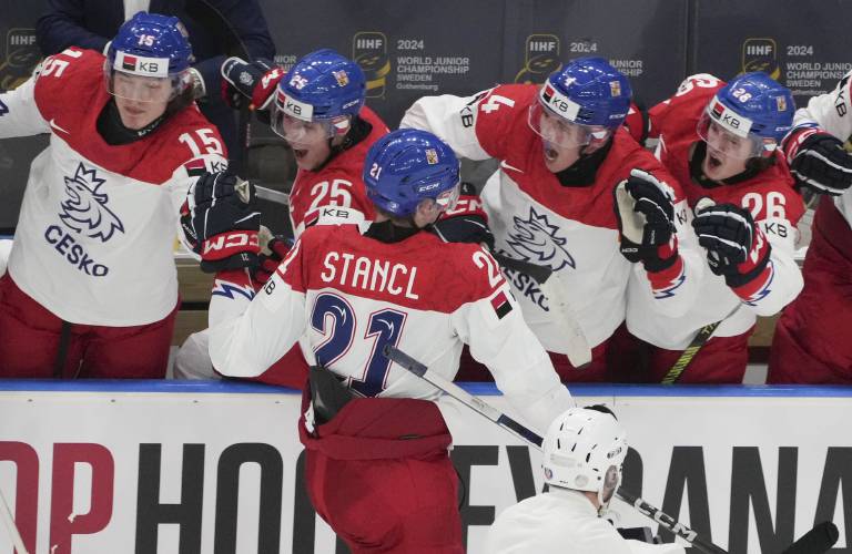 Czechia's Jakub Stancl (21) celebrates his game-winning goal with teammates during the third period of a quarterfinal match at the IIHF World Junior Hockey Championship in Gothenburg, Sweden, Tuesday, Jan. 2, 2024. Christinne Muschi/The Canadian Press via AP)