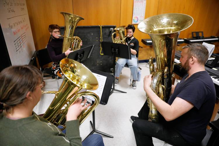 Brass Collective members Maura Riel, and Jay Witbeck, front, practice with tuba player Kaitlin Blasko, back left, and euphonium player Rylee Moore.