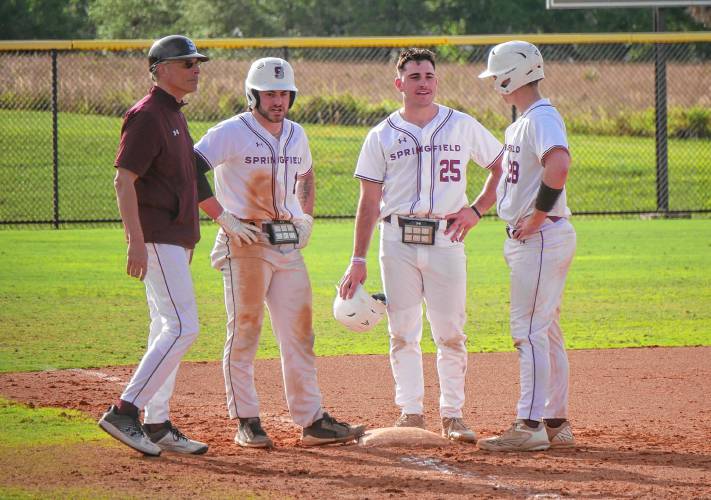Springfield College baseball coach Mark Simeone (far left) talks to his team during a game against Central College in Auburndale, Fla. on Sunday.
