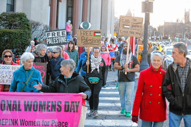 Dozens of community members march down Main Street after rallying at City Hall in Northampton on Friday as part of CODEPINK’s 19th annual celebration of International Women’s Day with the theme, “We mourn, we resist, we organize: Peace & Justice for the Palestinians and all peoples.”