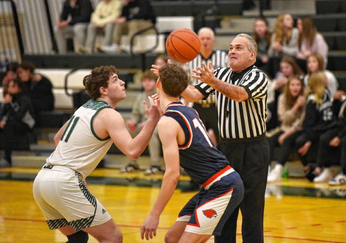 Referee Mark Grumoli tosses the jump ball to start the game between  the Greenfield and Frontier boys basketball teams  at  Nichols Gymnasium in Greenfield Tuesday night.  