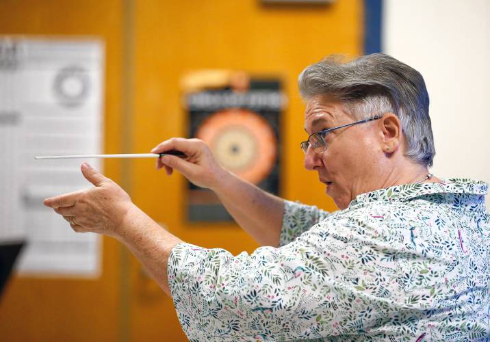 Bombyx Brass Collective music director Margaret Reidy conducts the South Hadley High School band during class Tuesday morning at the high school.