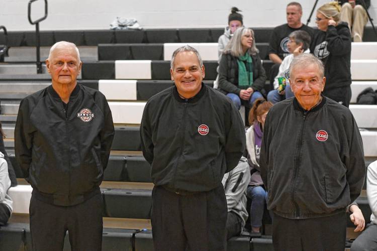 Referees Mike Korpita, Mark Grumoli and Bob McGee get ready to officiate the boys basketball game between Greenfield and Frontier at Nichols Gymnasium in Greenfield Tuesday night.  