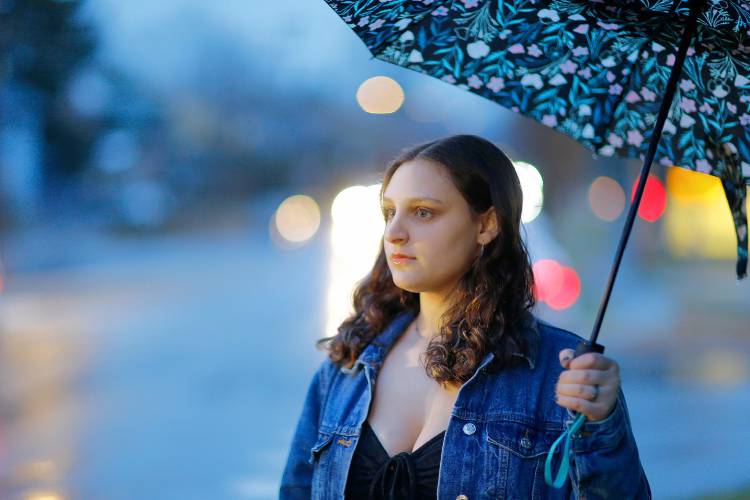 Northampton High School junior Maayan Seltzer, 16, stands for a portrait on a rainy Friday evening in Northampton.
