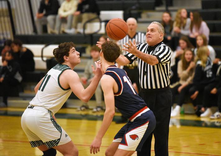 Referee Mark Grumoli tosses a jump ball at the start of a Greenfield-Frontier basketball game at Nichols Gymnasium in Greenfield.