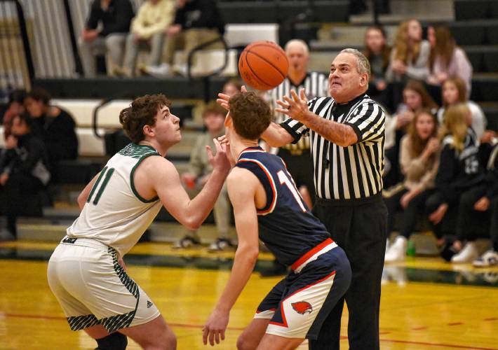 Referee Mark Grumoli tosses the ball up for the start of the Greenfield vs Frontier basketball game at  Nichols Gymnasium in Greenfield Tuesday night.  