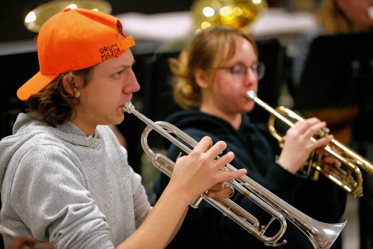 South Hadley High School band members Michael Beauchemin, left, and Lauren Brown run through music with the Bombyx Brass Collective during class Tuesday morning at the high school.