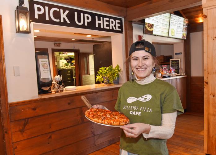 Millie Jacoby with a personal pizza at the Deerfield location of Hillside Pizza at the Yankee Candle store.
