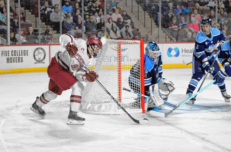 UMass freshman Jack Musa (9) tries to sneak a shot past Maine goalie Albin Boija during action earlier this season at the Mullins Center. Both schools will play in the Springfield Regional at this week’s NCAA Division 1 Men’s Ice Hockey Tournament at the MassMutual Center along with Denver and Cornell.